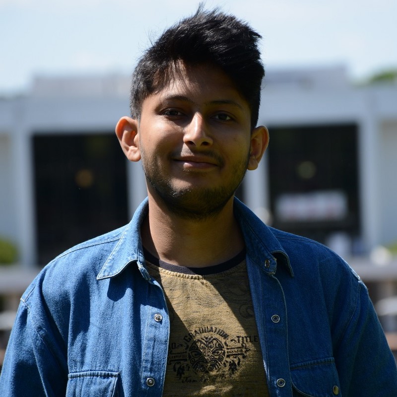 Nishant Deshpande standing with the Clemson University library in the background